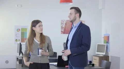 Happy and friendly office workers chatting during a break Stock Footage 73994201