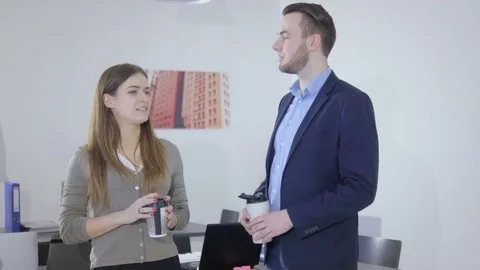 Happy and friendly office workers chatting during a break Stock Footage 73994418
