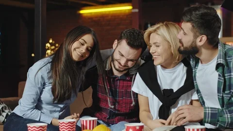 Happy and good looking group of friends have a good evening time together at Stock Footage 124471189