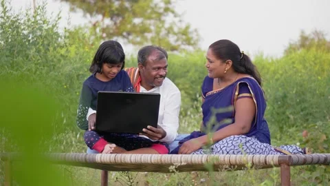 Happy and interactive rural farmer couple is talking online video call Stock Footage 168067782