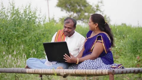 Happy and interactive rural farmer couple is talking online video call Stock Footage 168067837