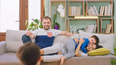 Happy and smiling large young family have a fun time with their small kids they Stock Footage 127915152