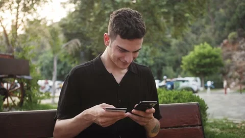 Happy and smiling middle eastern man making card payment using mobile phone Stock Footage 210481861