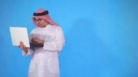 Happy Arab with a laptop he learned about winning Stock Footage 106989489