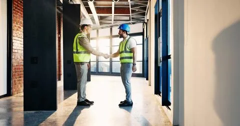 Happy, architect and men in building, handshake and agreement for property .. 库存照片