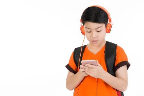 Happy asian boy using cell phone . Stock Photos