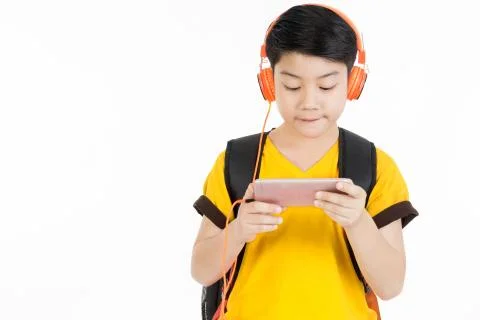 Happy asian boy using cell phone . Stock Photos