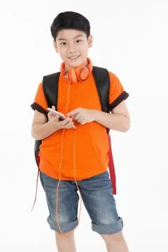 Happy asian boy using cell phone . Stock Photos