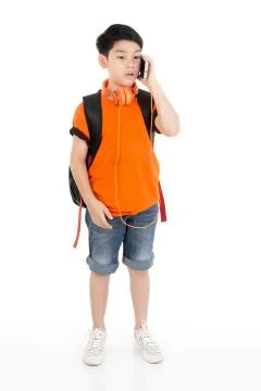 Happy asian boy using cell phone . Stock Photos