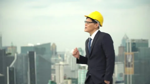 Happy asian business man of  architect wearing hardhat walking and sing a son Stock Footage 143150341