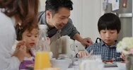 Happy Asian Family Eating Pancakes For Breakfast Children Enjoying Healthy Stock Footage