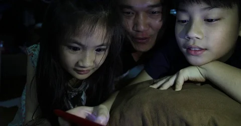 Happy asian family father and child watchung on tablet computer Stock Footage