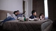 Happy Asian Family With Kids Watching Tv On Bed Stock Footage