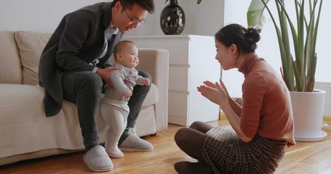 Happy asian family with newborn baby girl at home Stock Footage