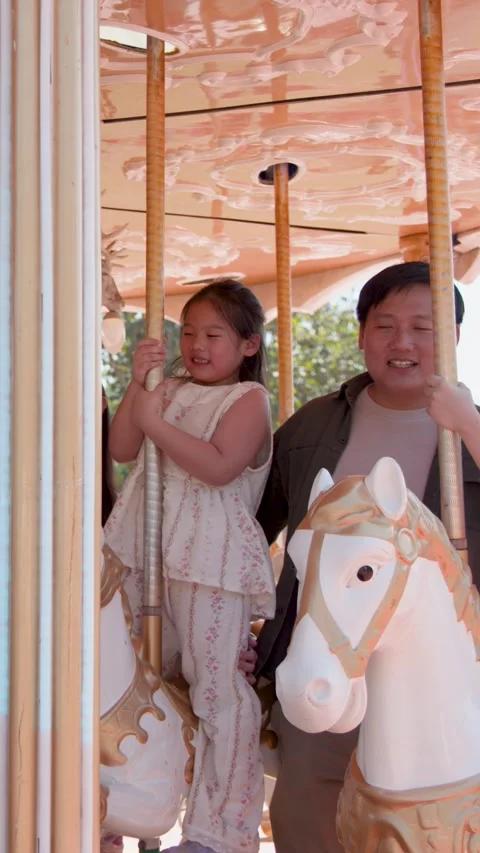 Happy Asian Family Taking Selfie on Carousel Horse at Amusement Park 스톡 동영상 340243053
