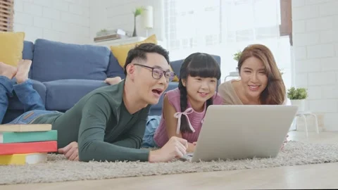 Happy Asian family using computer laptop together on sofa at home living room Stock Footage 152253405
