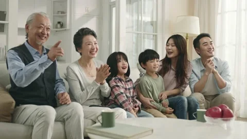 happy asian family watching tv together ... | Stock Video | Pond5