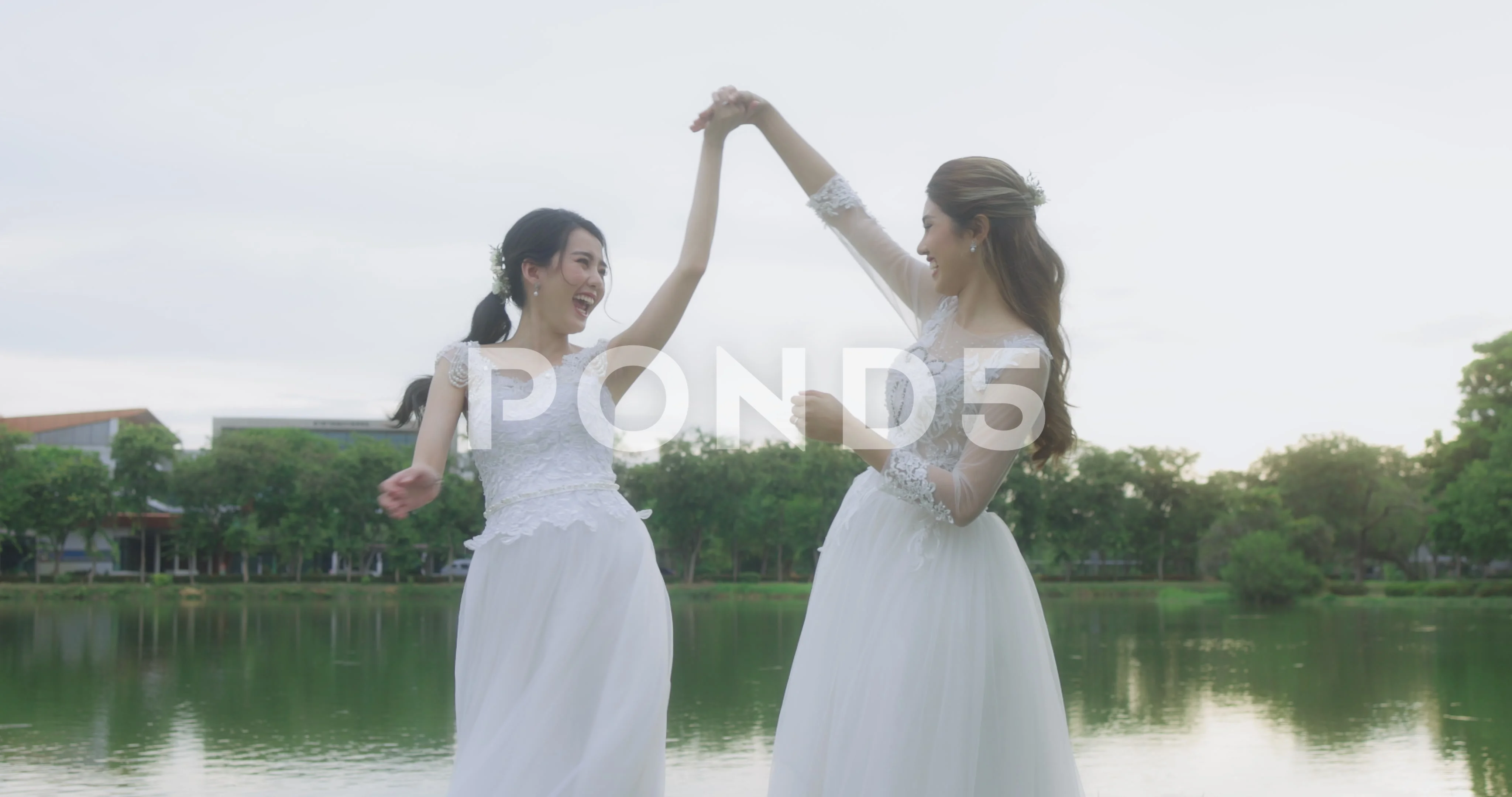 Happy Asian Lesbian Married Couple Dancing In The Park.