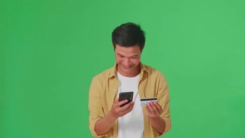 Happy Asian Man Using Mobile Phone With Credit Card For Shopping Online Stock Footage 161827590