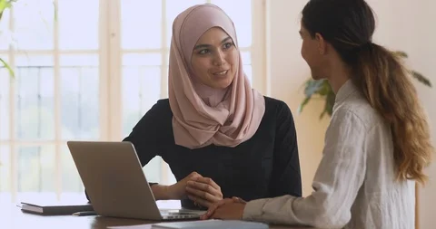 Happy asian muslim manager handshaking caucasian female client at meeting Stock Footage