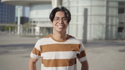 Happy asian Student. Guy smiling at camera outdoors on campus of university Stock Footage 207241489