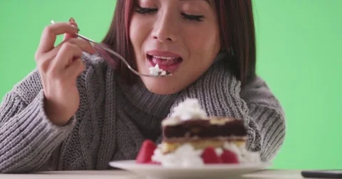 Happy asian woman eating cake on green screen Stock Footage
