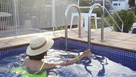 Happy asian woman having fun in swimming pool Stock Footage 100122953