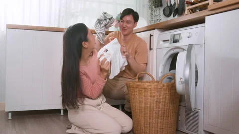 Happy Asian young couple doing laundry together at home , healthy lifestyle.. Stock Footage 228785949