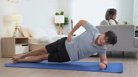 Happy asian young man doing exercise and watching tutorial on laptop with m.. Stock Footage 252816654