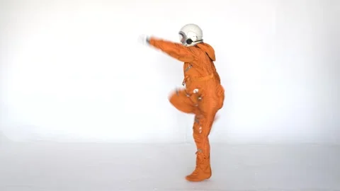 Happy astronaut having fun while dancing on a white background Stock Footage 258351380