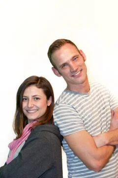 Happy attractive couple posing back to back Foto stock