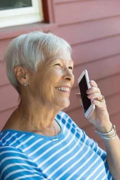 Happy Attractive Senior Woman talking on mobile Smartphone Stock Photos