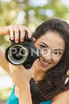 Happy attractive woman holding her camera Stock Photos