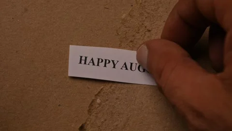 Happy August Message on Paper Note Placed by Hand Stock Footage 338268540