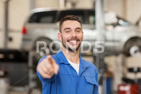 Happy auto mechanic man or smith at car workshop Stock Photos