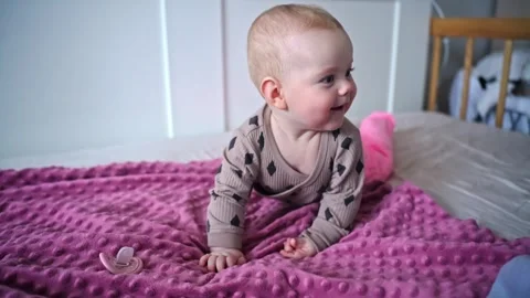 Happy baby on bed, front close up view Stock Footage 307906138