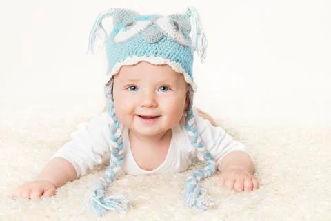 Happy Baby in Blue Knitted Hat, Kid Boy Raising Head, Smiling Infant Child Stock Photos