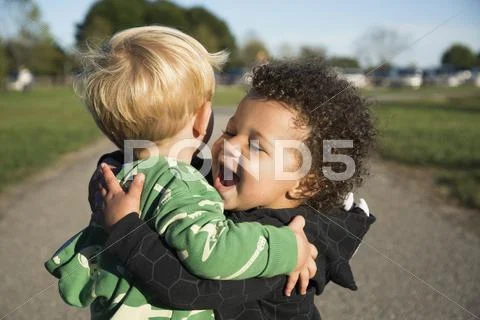 Happy Baby Boys Hugging Outdoors