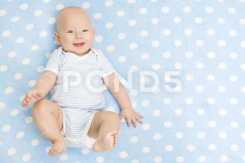 Happy Baby lying on Blue Carpet Background, Top View, Smiling Infant Kid Boy Stock Photos