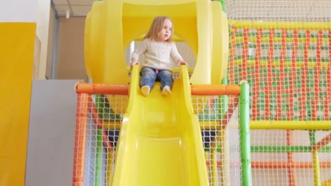 Happy baby riding down slide, children's play center, kindergarten, funny Video stock 171875053