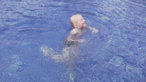 Happy baby waddling in the summer pool. Stock Footage 106980681