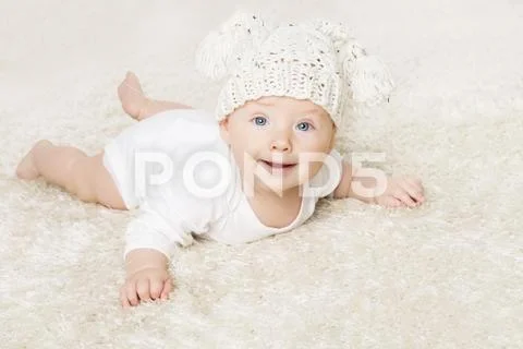 Happy Baby in White Knitted Hat Crawling on White Blanket, Infant Kid Boy Stock Photos