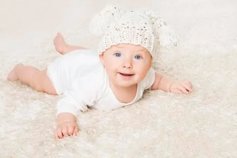 Happy Baby in White Knitted Hat Crawling on White Blanket, Infant Kid Boy Stock Photos