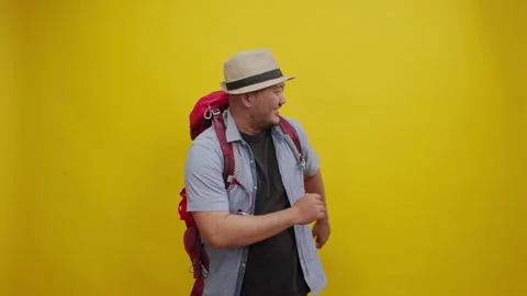 Happy Backpacker Dancing with Excitement, Isolated on a Yellow Background Stock Footage 336996334