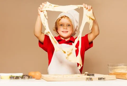 Happy baker looking through the big hole of dough Stock Photos