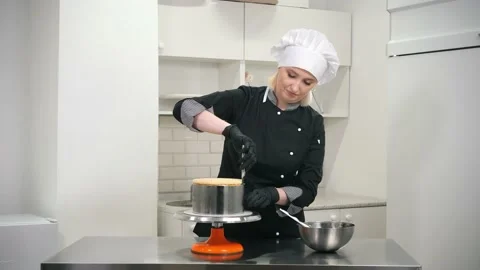 Happy baker separates cake from baking dish with knife Video stock 139486950