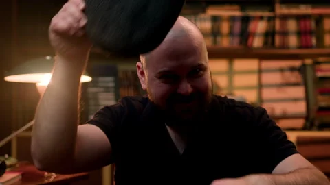 Happy bald bearded man looking at the camera and taking off his hat and glasses Stock Footage 273930053