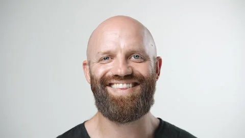 Happy bald man with red head beard. White teeth smile. Redhead guy face portrait 動画素材 250601030