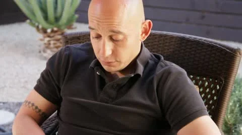 Happy Bald man smiles reading iPhone text Stock Footage