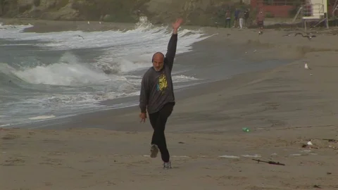 Happy beach dancer on beach in Laguna Beach, California USA Stock Footage 101488605
